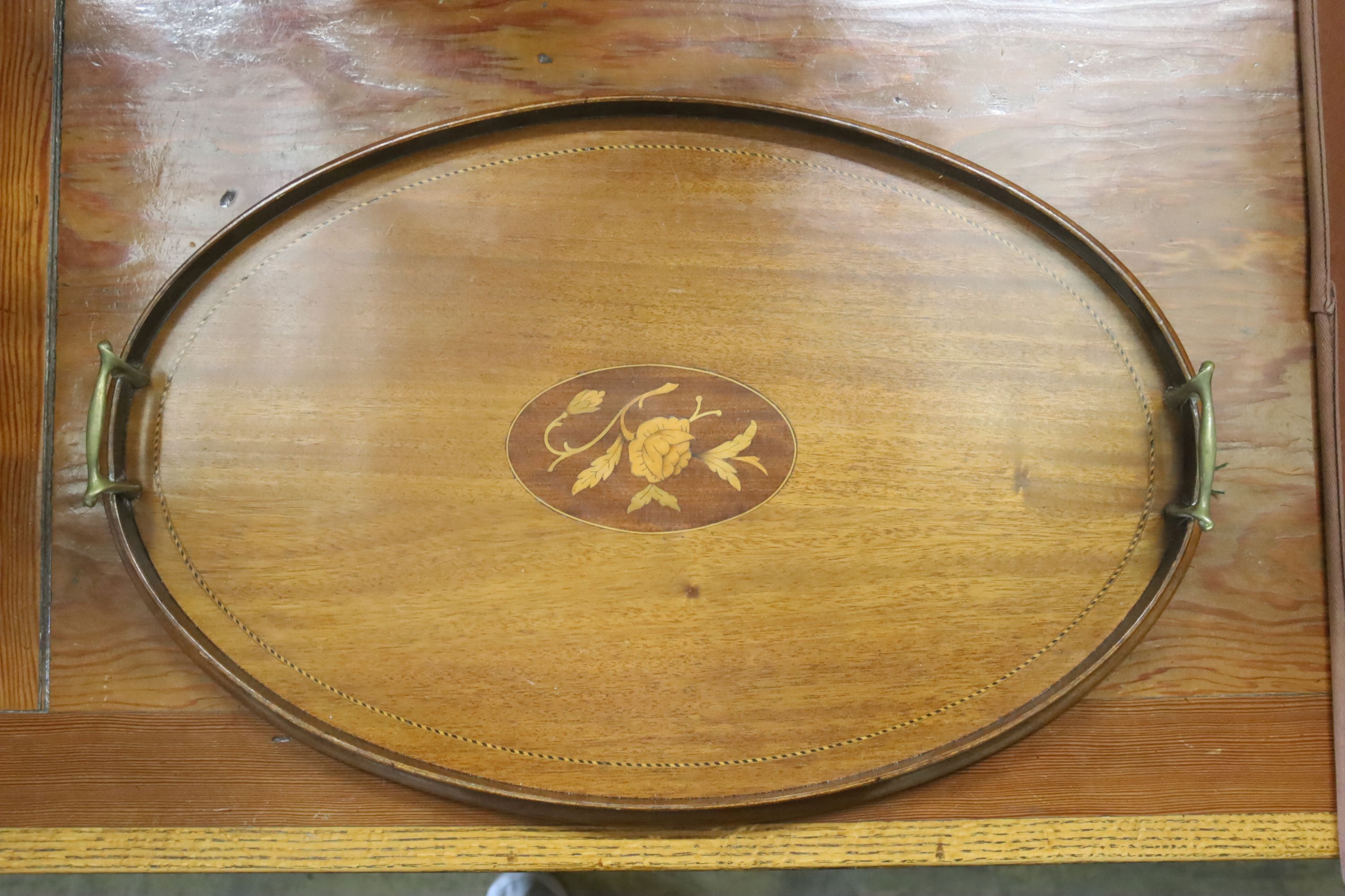 A Victorian walnut circular tripod table (a.f.) and an Edwardian inlaid oval tea tray
